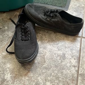 All black low top Vans